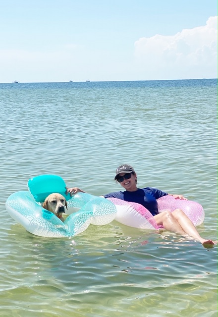 A person swimming in a body of water

Description automatically generated